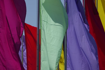 multicolor plain flags on blue sky background