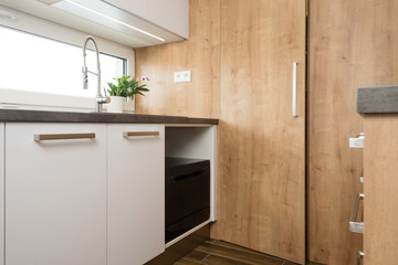 Interior of modern kitchen with built-in appliances