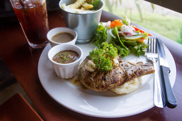 Pork chop, served with mashed potato and salad included.