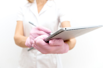woman doctor, nurse, scientist in white coat with tablet