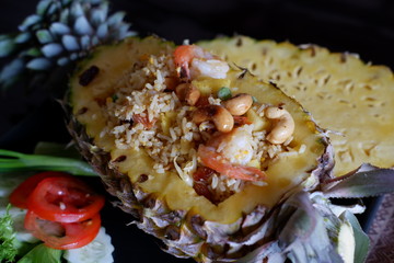 Fried rice with pineapple on wooden table