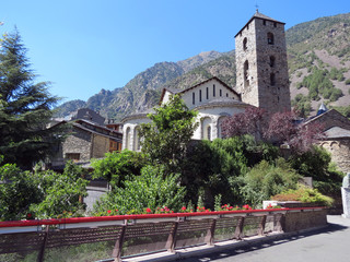 Beautiful medieval building with a tower  on the background of the Pyrenees mountains,  view in good summer weather, Andorra, Europe.