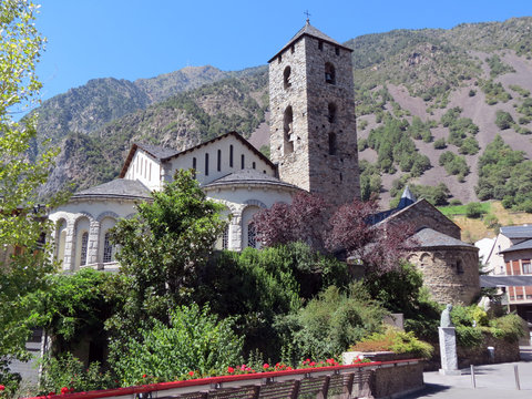 Beautiful  building with a tower  on the background of the Pyrenees mountains,  view in good summer weather, Andorra, Europe.