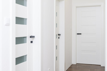 Hallway with white closed doors in apartment