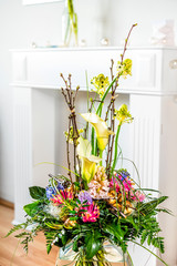 Flower bouquet in living room in front of a fire place