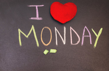 handwriting i love monday on chalkboard with colorful chalk and wooden heart