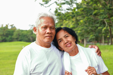 Older Asian couples exercise in the park.