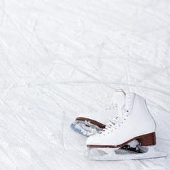 figure skates and copy space over ice with marks from skating © Di Studio