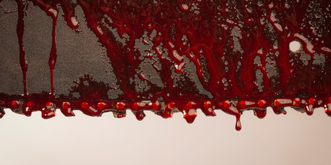 detail of bloody chainsaw - obrazy, fototapety, plakaty