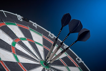 Darts, three darts in a bull's eye.