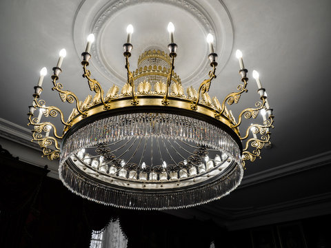 Old Vintage Chandelier With Light Candles In A Palace Ceiling, Living Room.