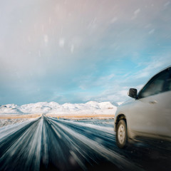 Fototapeta na wymiar fast driving car on snowy iceland road