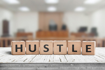 Hustle sign with text on a worn desk