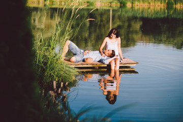 young love couple at the lake in summer sunset