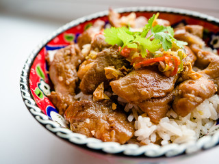 Deep fried pork with rice cook at home served by Turkish bowl on a wooden table.