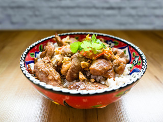 Deep fried pork with rice cook at home served by Turkish bowl on a wooden table.
