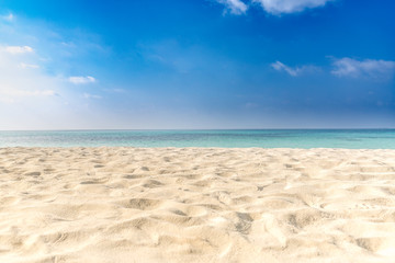 Fototapeta na wymiar Calm beach scene, sand, sky, sea. Relaxation and inspiration concept