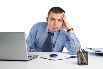 Fototapeta premium Frustrated young businessman working on laptop computer at office