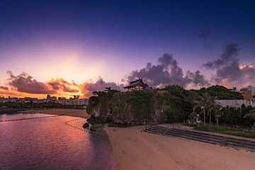 Sunrise landscape of the Shinto Shrine Naminoue at the top of a cliff overlooking the beach and ocean of Naha in Okinawa Prefecture, Japan.
