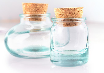 The Small empy glass with a cork isolated on a white background.