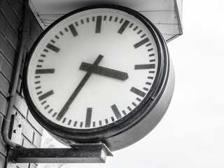 Public classic urban analog big clock hang with roof train railway station terminal, Beautiful clock, watch black white tone, Concept of time, appointment, deadline, meeting business, travel schedule