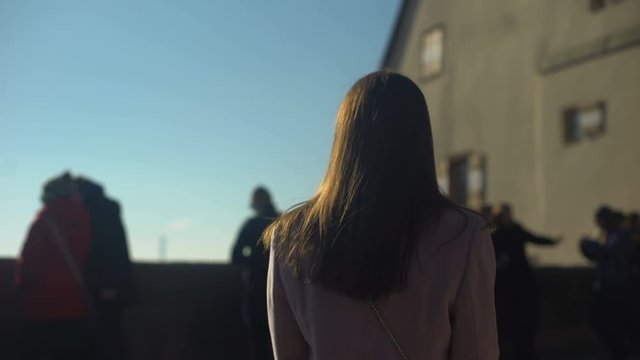 Pretty lady visiting skydeck in old european town, woman traveller enjoying view