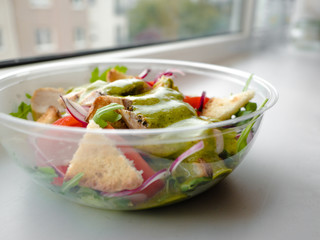 Healthy simple Chicken salad with tomatoes, arugula, green salad dressing and bread croutons in the a glass bowl, Vinaigrette For Green Salad Recipe.