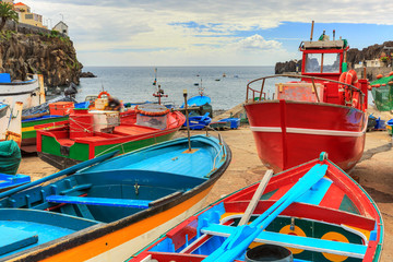 Beautiful view of the colored fisher boats in the Harbor of Camara de Lobos on the island of...