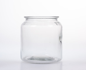Glass jar with lid on white background