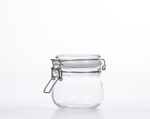 Glass jar with lid on white background