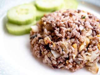 Healthy food Asian Thai style fried jasmine rice mixed with fragrance black rice (Hom Nil rice), popular menu in Thailand. Clean food