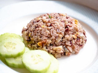 Healthy food Asian Thai style fried jasmine rice mixed with fragrance black rice (Hom Nil rice), popular menu in Thailand. Clean food