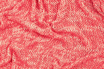 Knitted texture background coral top view flat