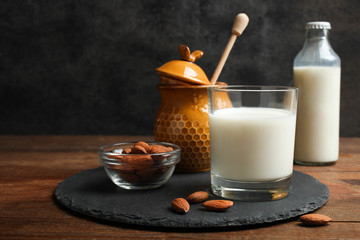 Glass of milk, jar of honey and almond nuts