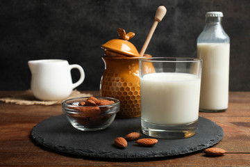 Glass of milk, jar of honey and almond nuts