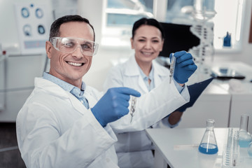 Smiling scientist is happy with his scientific achievements