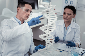 Scientist explaining his finding to his colleague