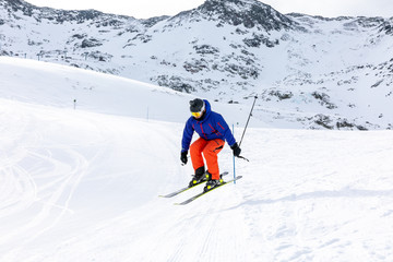 Naklejka na ściany i meble Man skiing on the ski slopes
