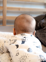Baby bald spots. The baby boy with dark brown hair turned back. Half mixed race Asian Caucasian 