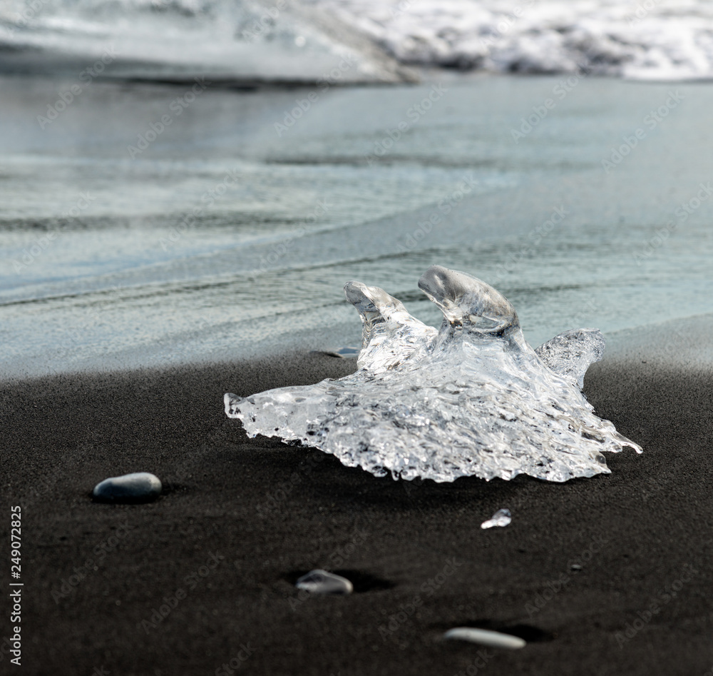 Poster Piece of ice on black sand