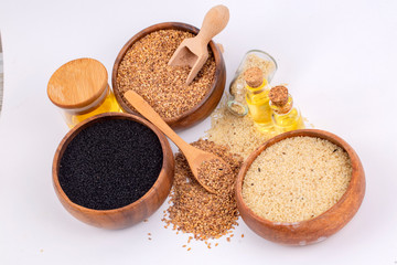 Bottle of sesame oil and sesame seeds isolated