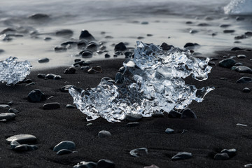 Crystal clear ice on seashore