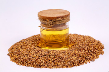 Bottle of sesame oil and sesame seeds isolated