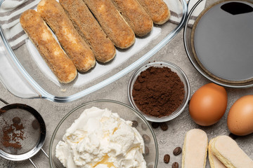 Ingredients for making traditional italian cake tiramisu on concrete table