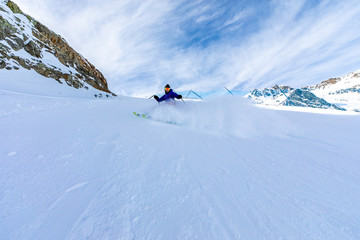 Fototapeta na wymiar Man skiing on the ski slopes