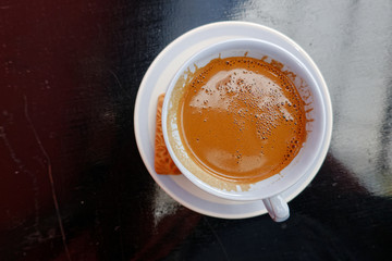 trditional Greek coffe in white porcelain cup top view