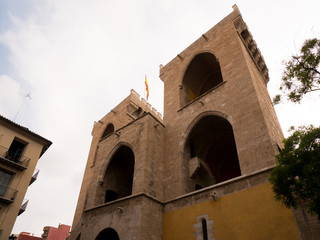 Spanish flag waving on the Torres de Quart, gateway to the medieval Christian wall of Valencia