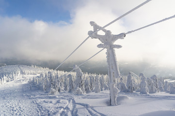 Ski tow on the top of mountain during winter. Snowy landscape scenery. Top of Lysa hora, Beskid mountains, Czech Republic, Europe.