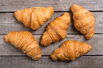 Croissants on wooden background
