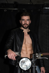 Fototapeta na wymiar Fashion portrait of young handsome and sexy biker man.